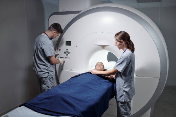 istock Young assistant preparing little girl for mri scan examination 1337470141