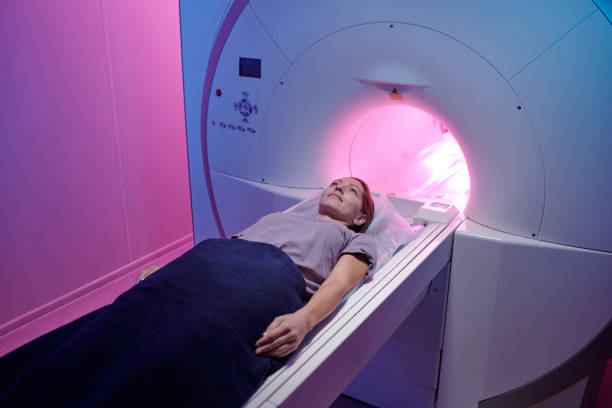 istock Young female patient lying on long table of mri scan machine 1337470180