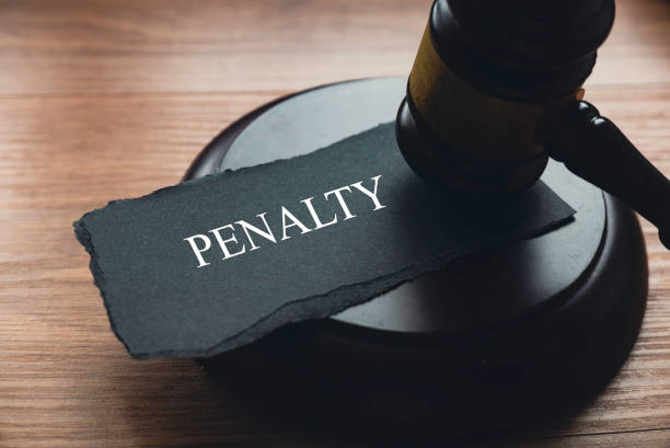 A gavel and a piece of paper written with Penalty. stock photo