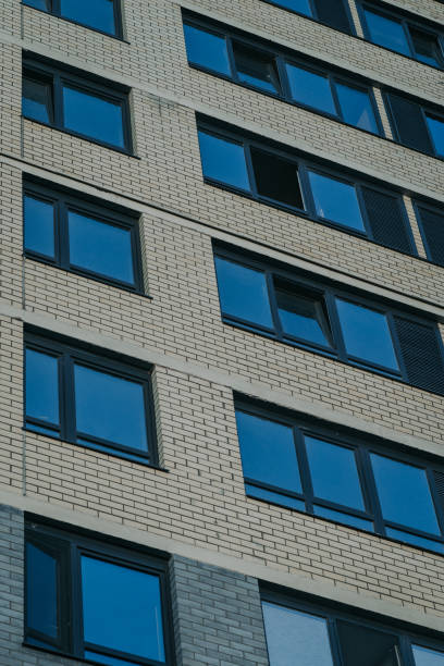 istock Two and three casement windows on a brick building sand-colored 1337471401