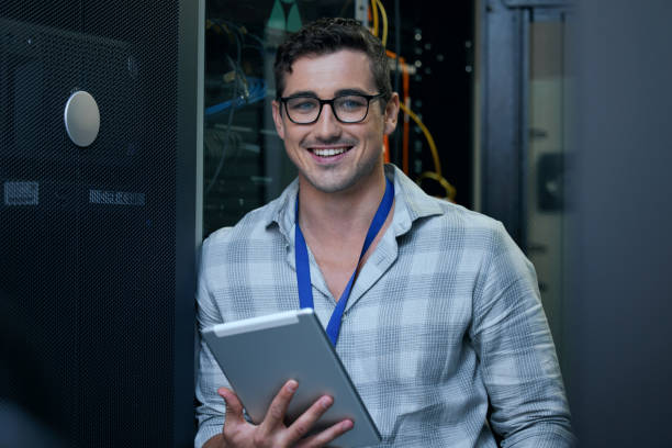 istock Cropped portrait of a handsome young male programmer working on a tablet in a server room 1337471402