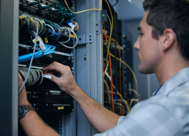 istock Cropped shot of a handsome young male programmer working in a server room 1337471404