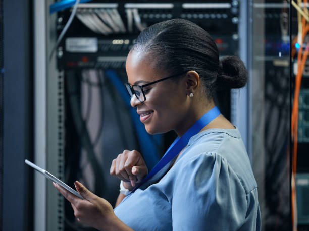 istock Cropped shot of an attractive female programmer working on a tablet in a server room 1337471416