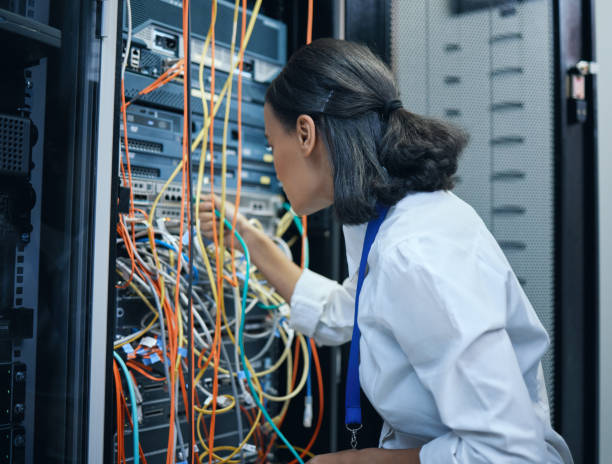 istock Cropped shot of an attractive young female programmer working in a server room 1337471421