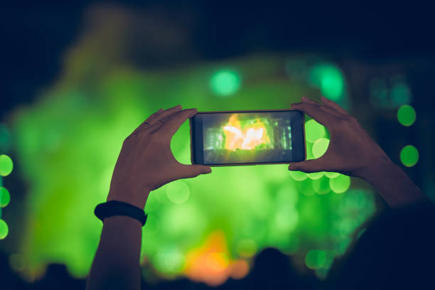 istock Person holding modern smartphone on a concert. 1337471438