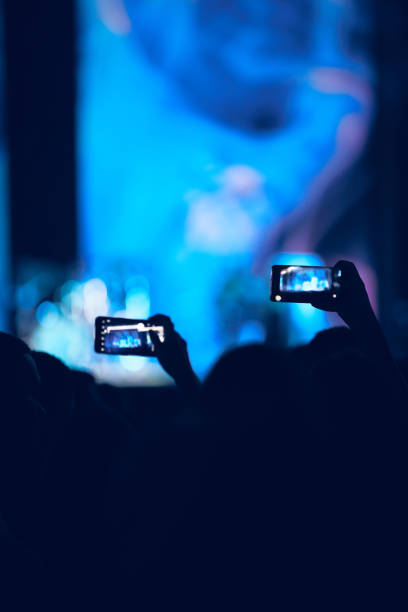 istock Person holding modern smartphone on a concert. 1337471461