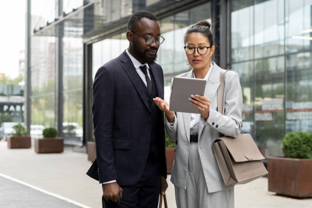 istock Two multiracial colleagues preparing presentation outdoors 1337472683