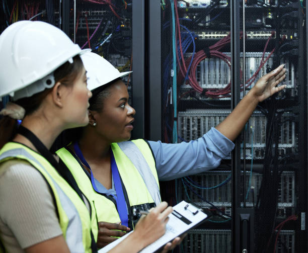 istock Cropped shot of two attractive female programmers working in a server room 1337475567
