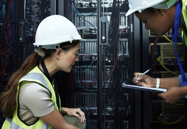 istock Cropped shot of two attractive female programmers working in a server room 1337475577
