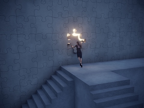 Woman climbed up the stairs and trying to push the puzzle piece on the wall and going through the bright light streaming from the hole in the wall. Can be used big idea, innovation, leadership concepts.  (3d render)