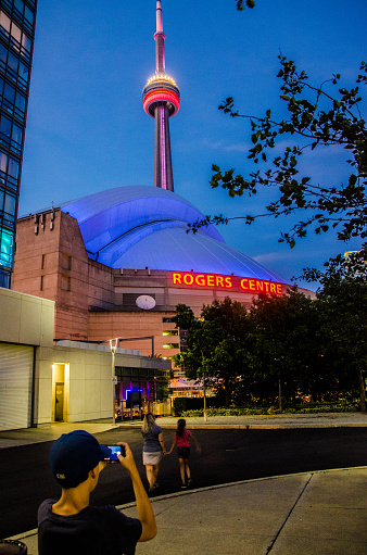 Illuminated CN Tower and Rogers Center at night during summer in Toronto