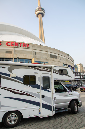 Motor home downtown Toronto with CN Tower in background during summer day