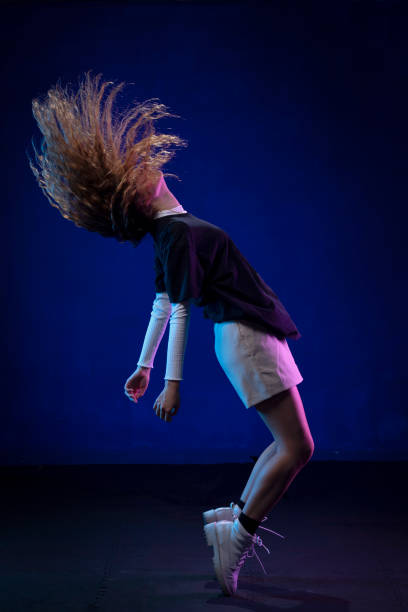 istock Mexican dancer with Chinese hair, making a pose in the studio, with blue background and casual clothes 1337482706