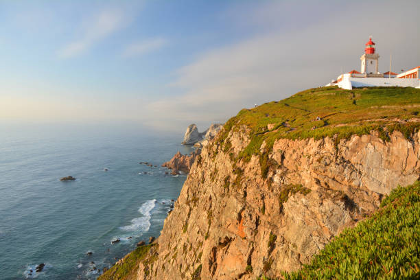 Cabo da Roca cape and lighthouse in Portugal Cabo da Roca cape and lighthouse in Portugal, most western point of continental Europe in sunset light. nature park stock pictures, royalty-free photos & images
