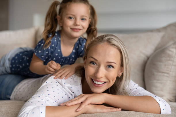 istock Happy mom with cute daughter girl resting on her back 1337484890