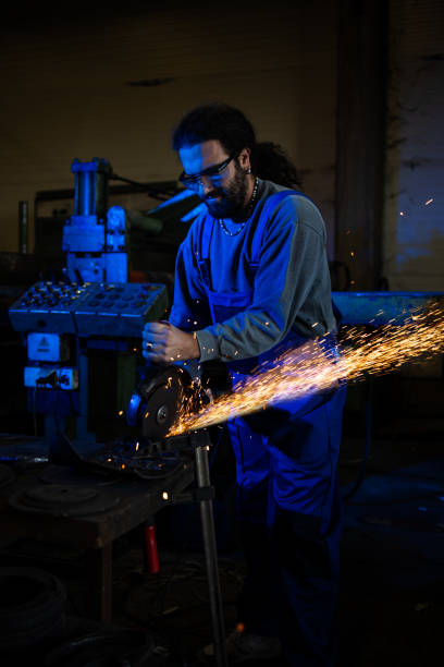 istock Heavy industry worker cutting steel with an angle grinder. 1337484954