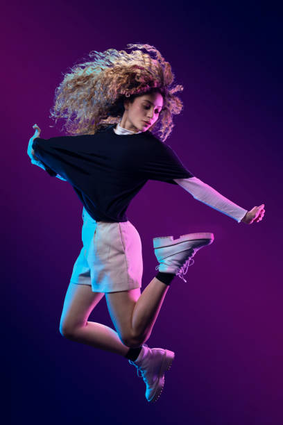 istock Mexican dancer with Chinese hair, making a pose in the studio, with blue background and casual clothes 1337485211