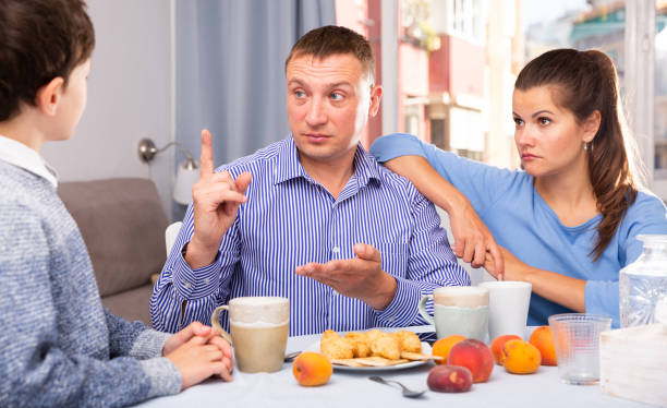 istock Father and mom scolding son in the kitchen 1337488405