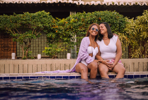 istock Lesbian couple by the pool 1337488455