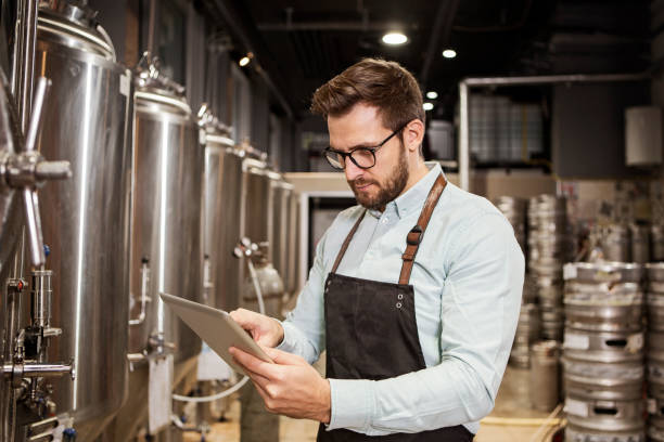 istock Technician checking quality of beer in brew house 1337494430