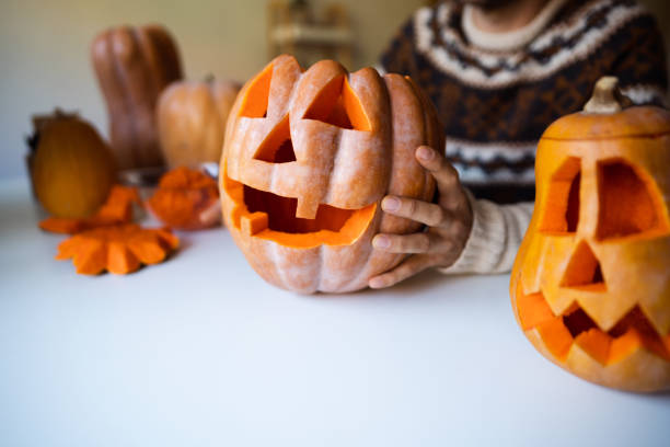 istock Unrecognizable man preparing a pumpkin for Halloween at home 1337495662