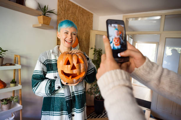 istock Happy couple capturing moments with smart phone while preparing pumpkins for Halloween 1337495676