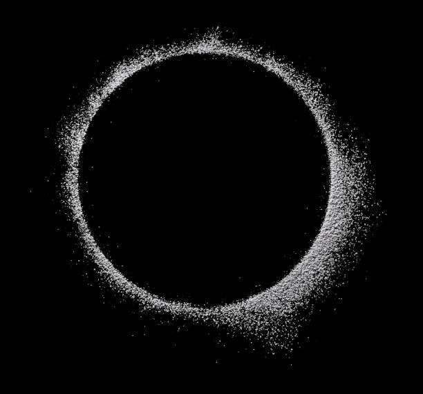 powdered sugar scattered in a round close-up isolated on black background