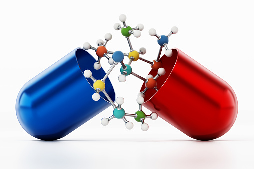 Fictitious molecule model inside red and blue pill isolated on white.