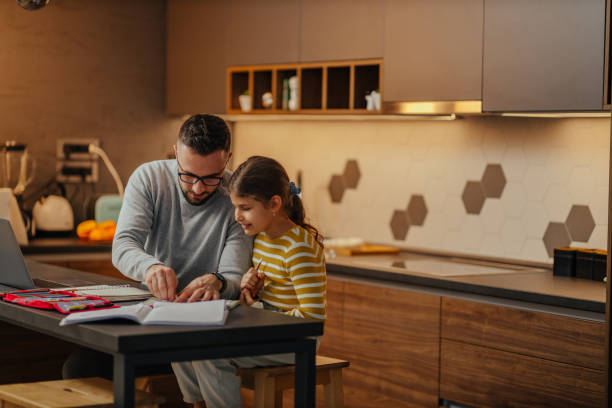 istock Father assisting his child about homework 1337502356
