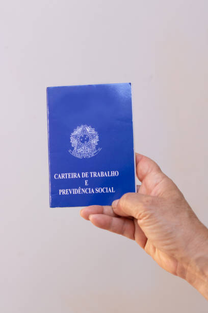 istock Holding a brazil work permit card, isolated on white background. Concept image. 1337503189