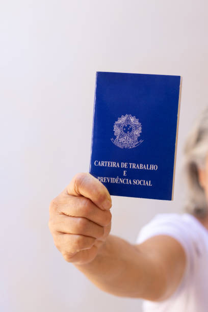 istock Holding a brazil work permit card, isolated on white background. Concept image. 1337503191