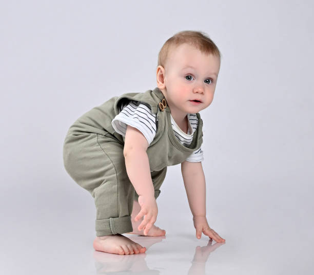 istock Happy child is sitting on floor, isolated over white 1337508027