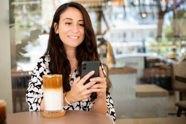 istock Woman holding ice latte glass 1337508579