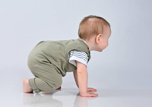 istock Cute baby girl crawling isolated on white 1337510167