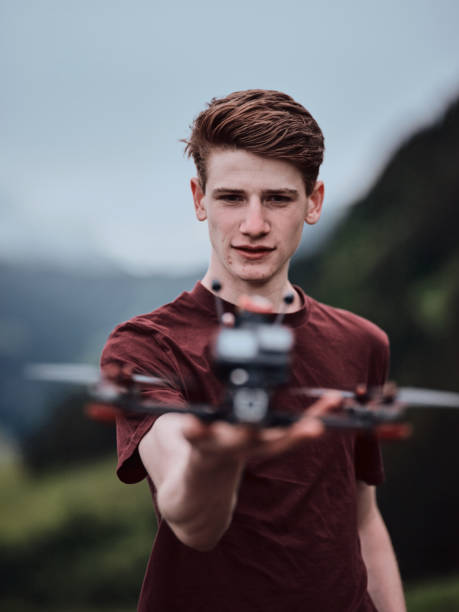 Young man prepares to fly a drone in the mountains