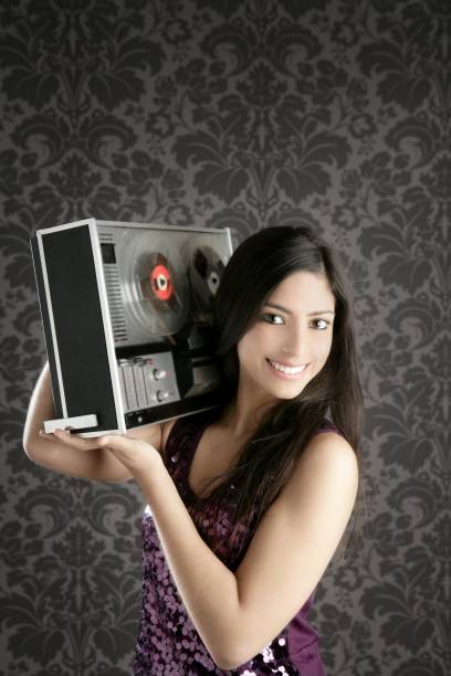 istock Retro open reel tape recorder beautiful brunette Dj 1337513085