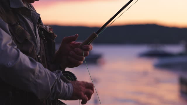 Senior Man Fly-Fishing at Sunset