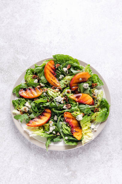 istock Salad with grilled peach, pecan nuts, blue cheese and arugula. 1337514074