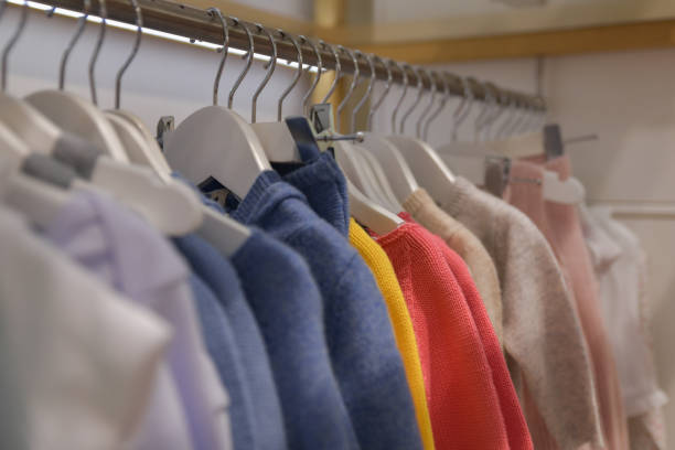 istock Blouses and sweaters hang on a hanger in the store 1337515599
