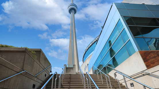 Toronto, Canada-5 May, 2021: Scenic CN Tower overlooking Ontario Lake. A panoramic view from the base of the tower to the top observation deck and Skypod lookout.