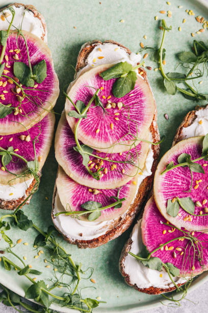 istock Watermelon radish toast with cream cheese and micro-green peas. 1337515908
