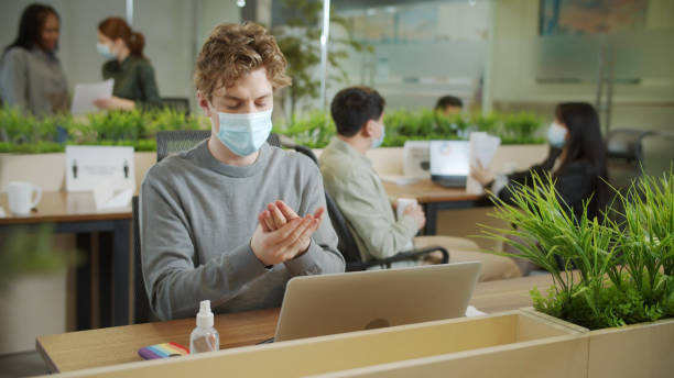 istock A young businessman is disinfecting his hands 1337516686