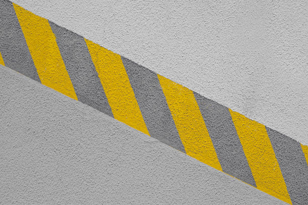 istock Yellow work safety line in factory on concrete wall 1337517359