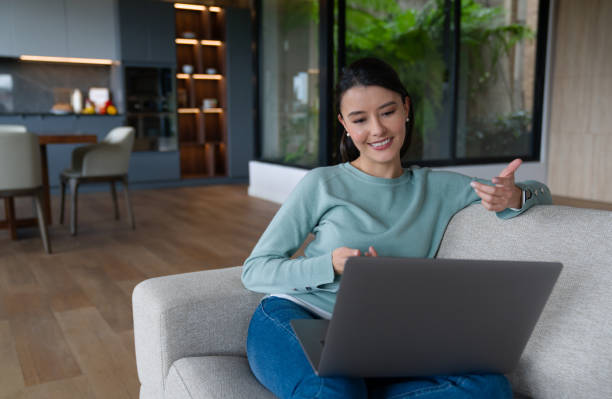 istock Happy woman at home talking on a video call 1337519441