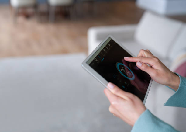 istock Woman controlling the temperature of her house using a home automation system 1337519447