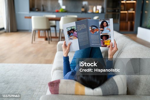 istock Woman relaxing at home reading a magazine 1337519463