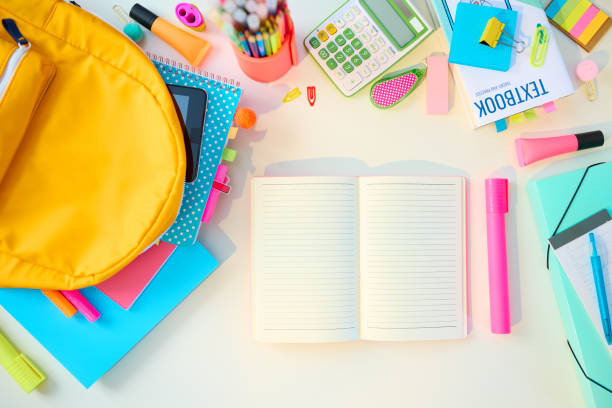 istock Upper view of white desk at student room in sunny day 1337520241