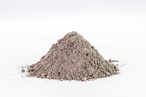 Cement dust pile on isolated white background, construction material.