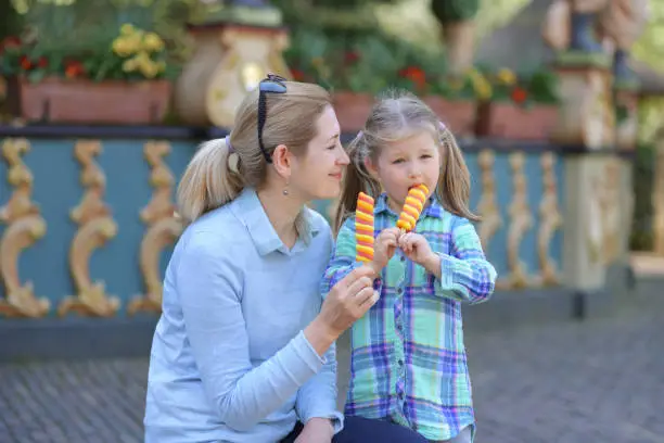 Mother and daughter enjoy ice cream in a park Efteling, Holland
