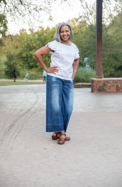 istock Senior woman outdoors smiles with hands on her hips 1337522634